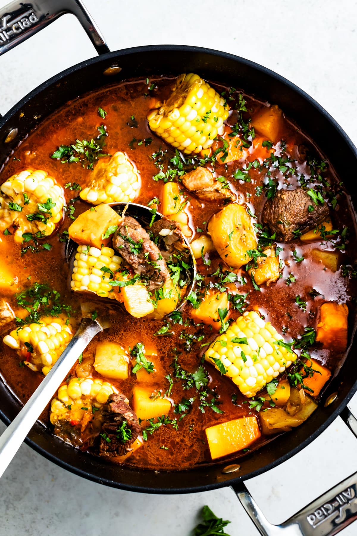 Overhead image of Sancocho in a pot with a ladle.