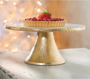Gold cake stand with a tart on it