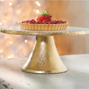 Gold cake stand with a tart on it