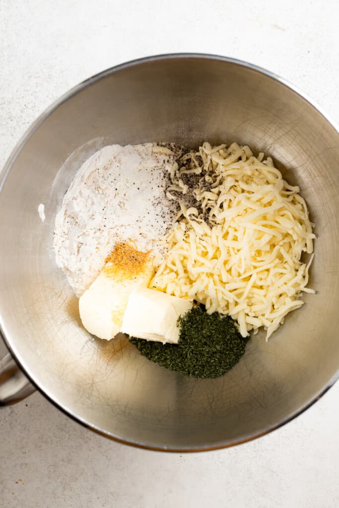 Ingredients for mozzarella stick dough in a mixing bowl before being mixed together.