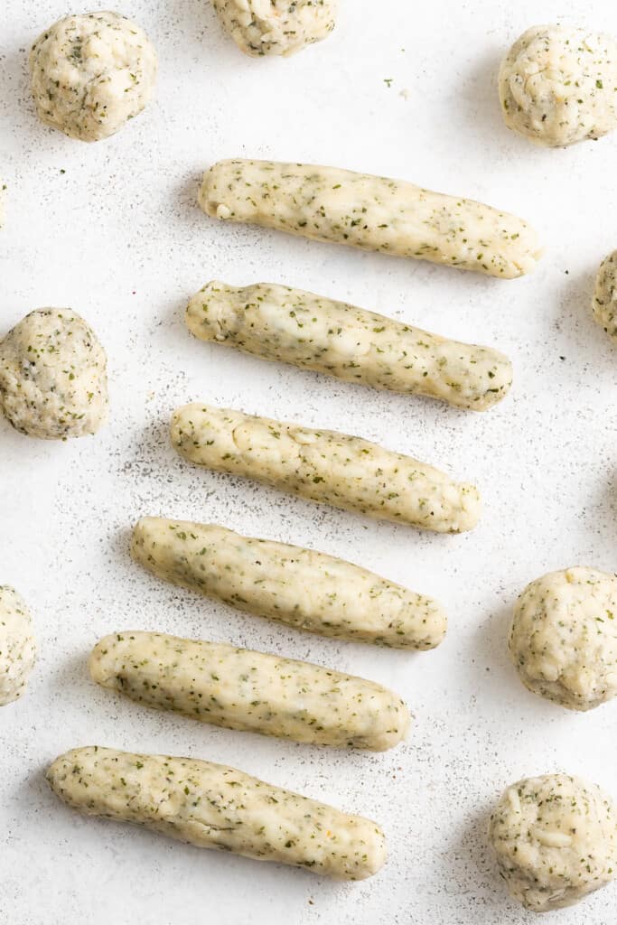 Dough for mozzarella sticks formed into balls and sticks.