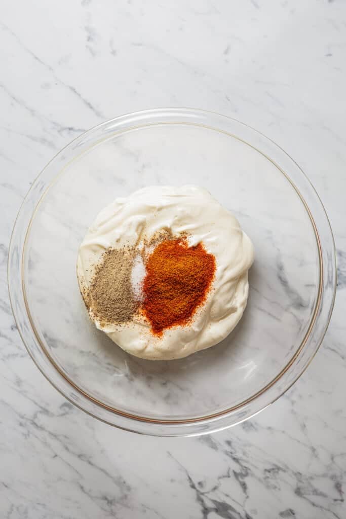 Making the yogurt marinade in a glass bowl