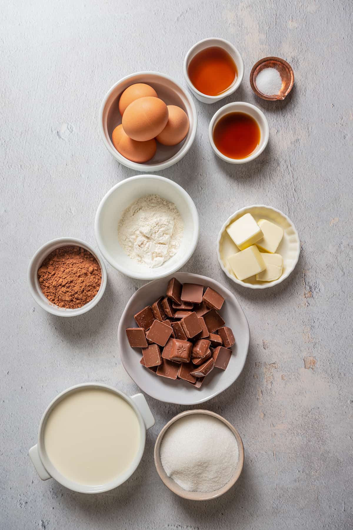 Ingredients for chocolate mousse cake separated into bowls.