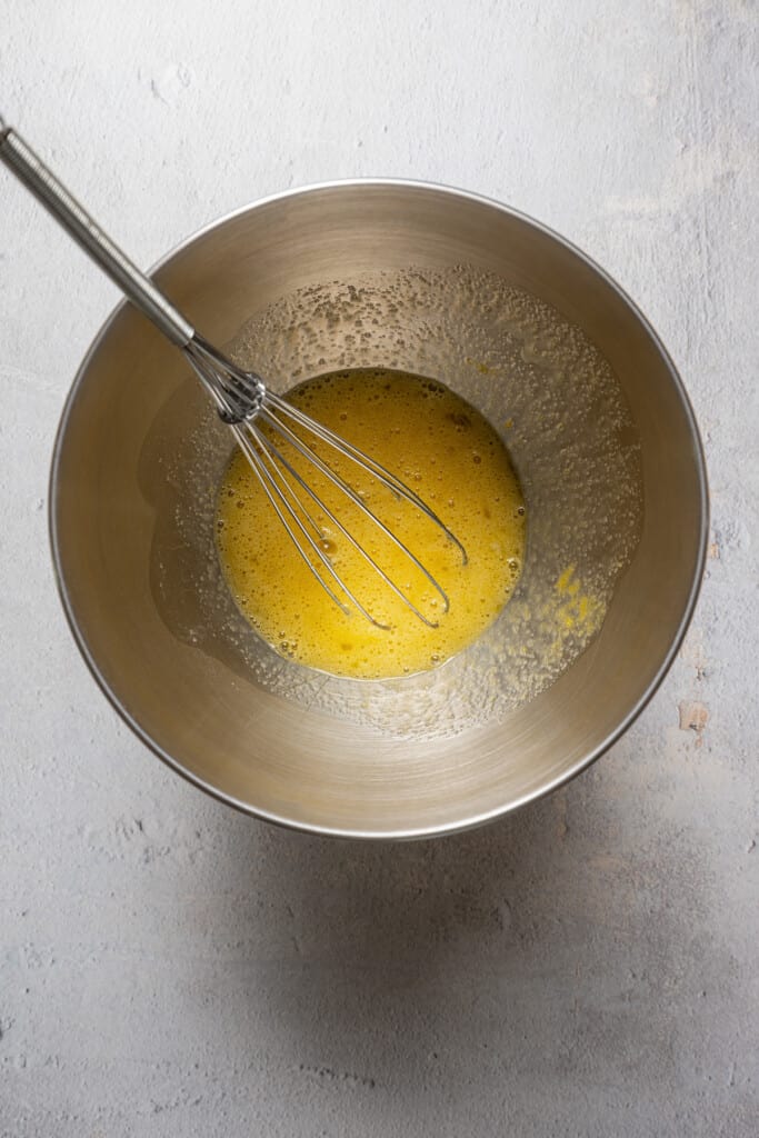 Whisking together eggs and sugar.