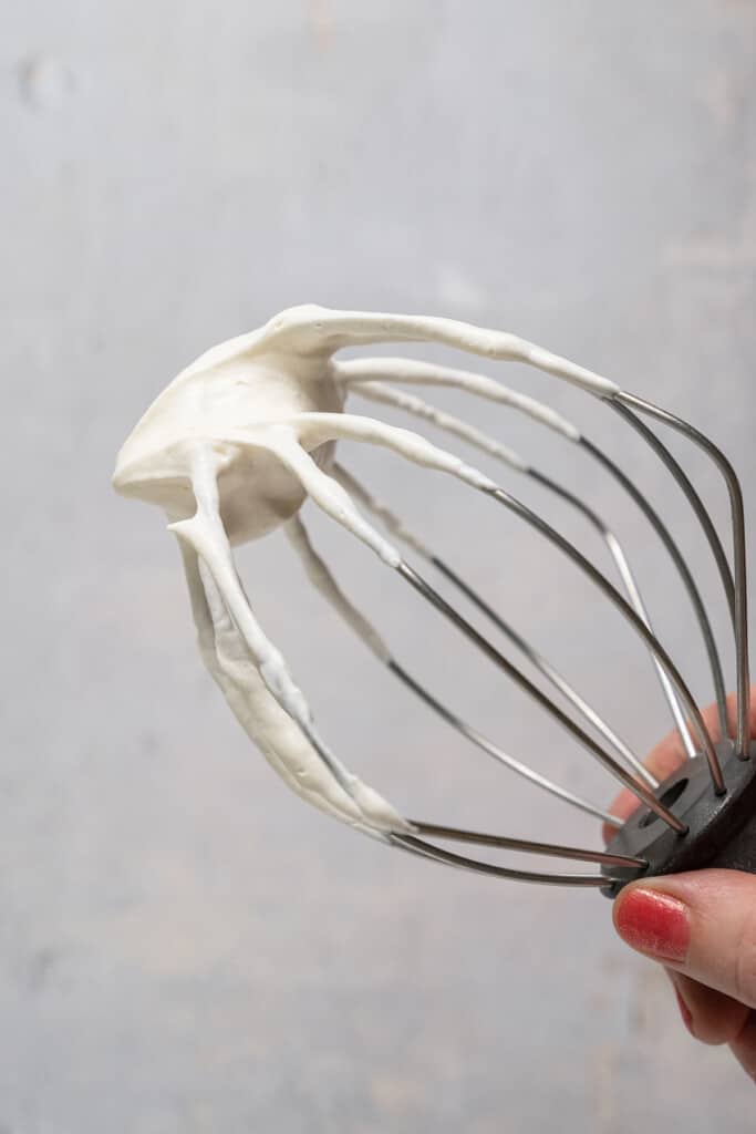 Whipped cream on a whisk attachment.