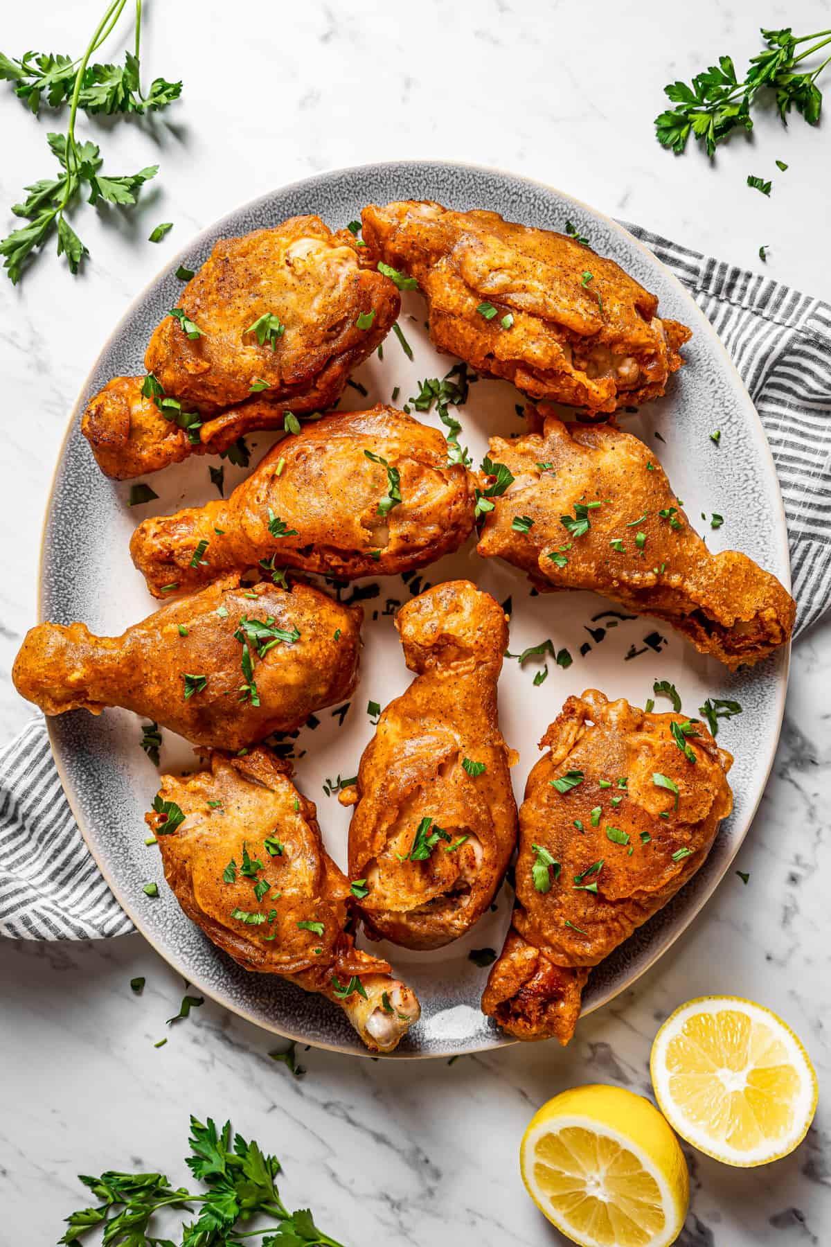 Overhead shot of beer-battered chicken arranged on a serving plate.