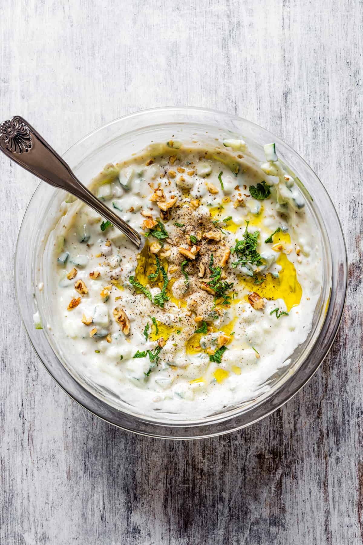 A bowl of taratur sauce with a spoon.