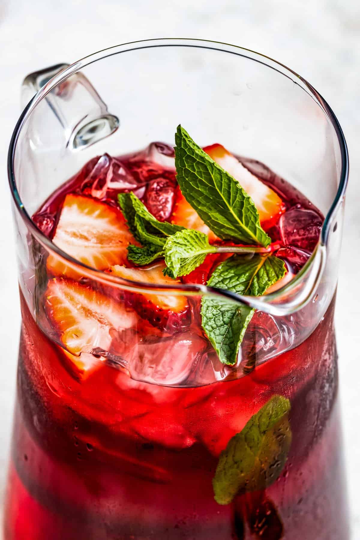 Glass Pitcher filled with hibiscus iced tea.