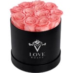 A black box filled with pink roses