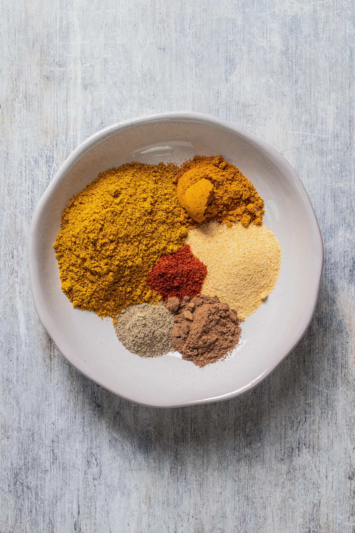 Spices for Jamaican curry in a bowl.