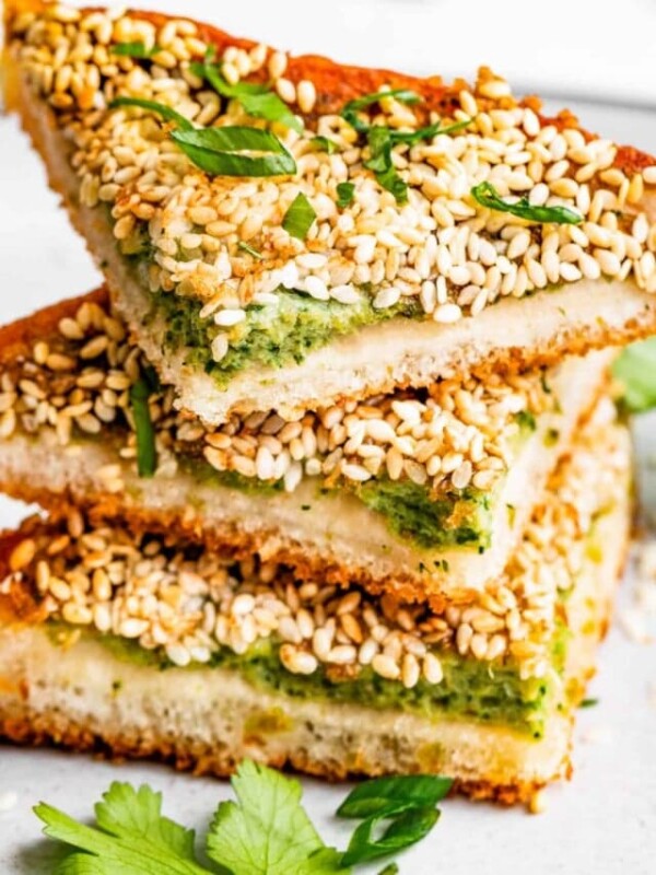 Close-up photo of shrimp toast triangles topped with sliced scallions.