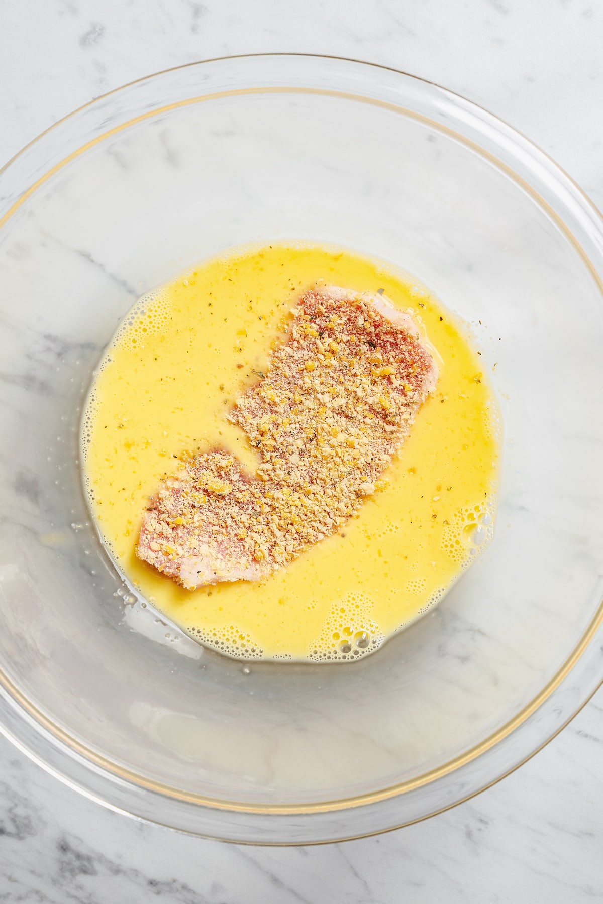 This crispy breaded pork chops recipe is an easy dinner, with juicy boneless pork chops coated in crunch and baked in the oven until golden. Dipping a breaded pork chop into a mixture of milk and eggs.