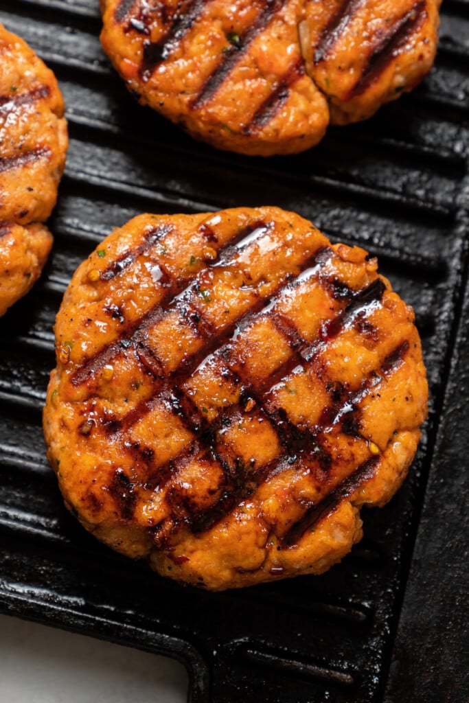Grilled salmon patties on a grill pan.