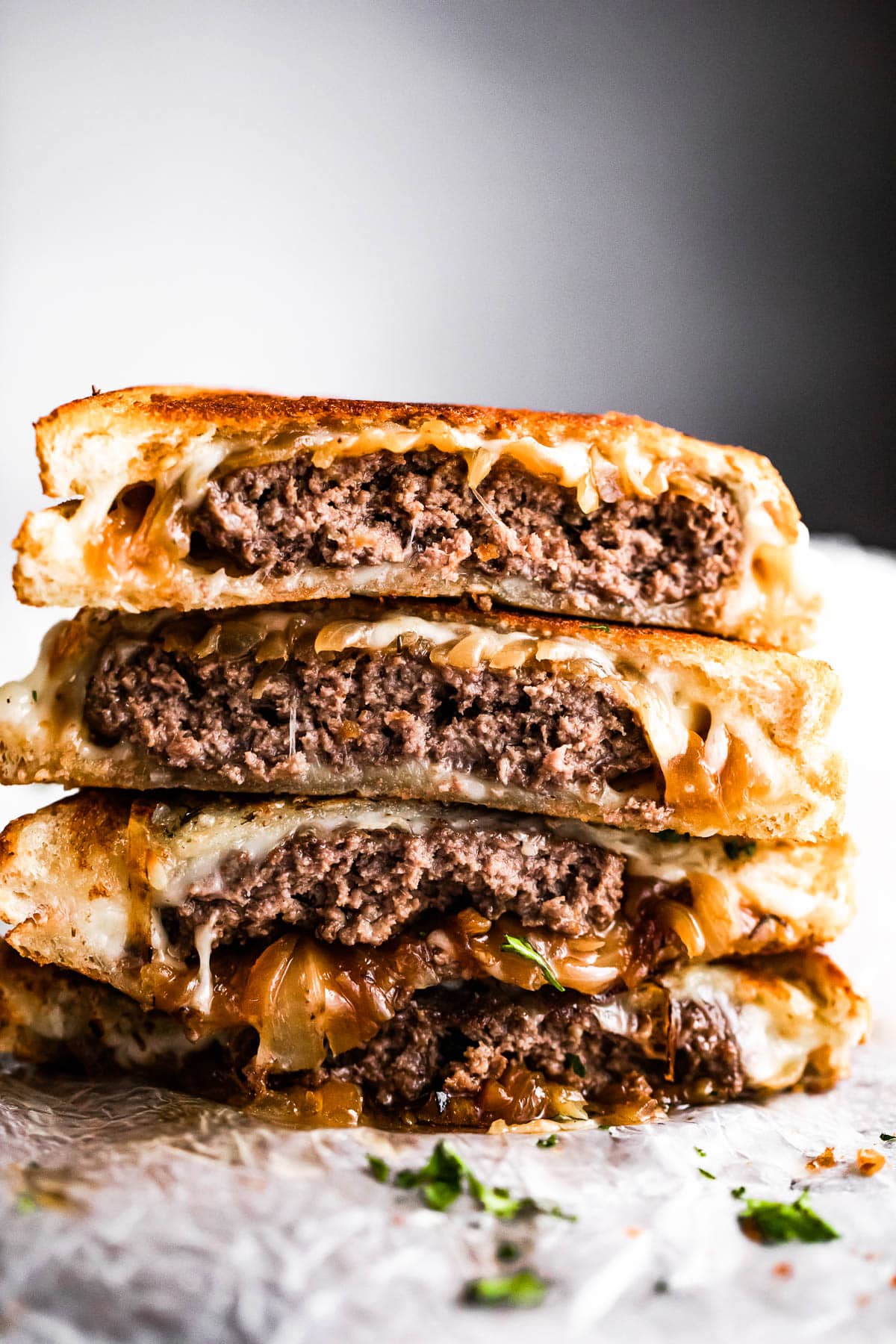 Classic patty melts cut in half and stacked.