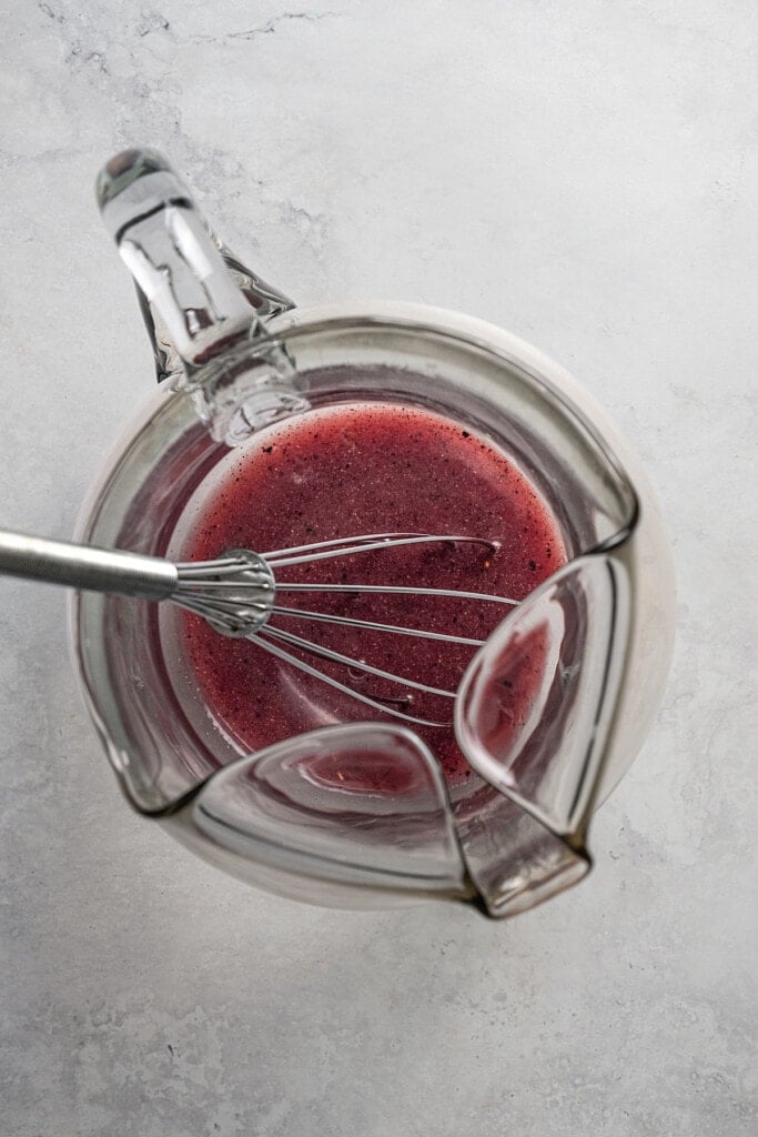 Fruit powders whisked together with water inside a pitcher.