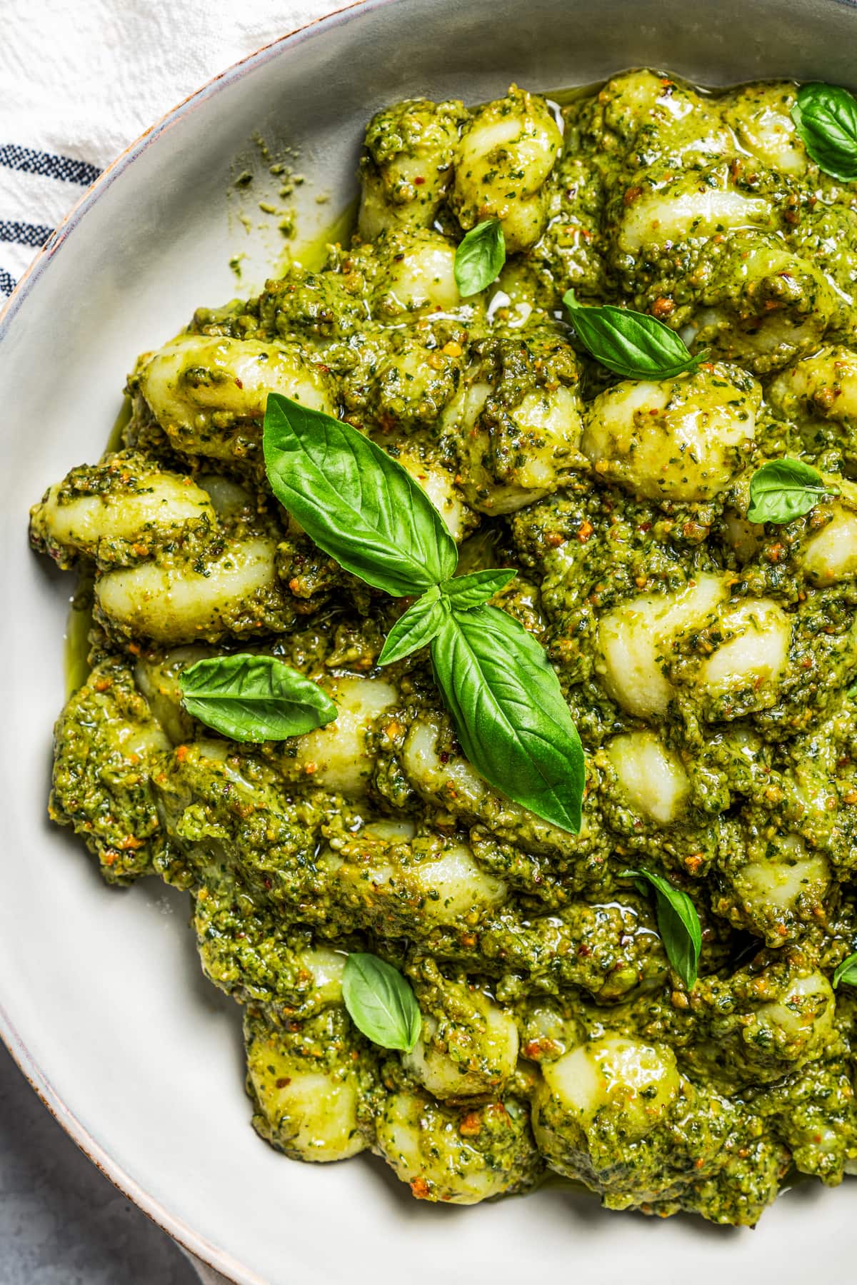 Overhead image of avocado pesto pasta served on a dinner plate.