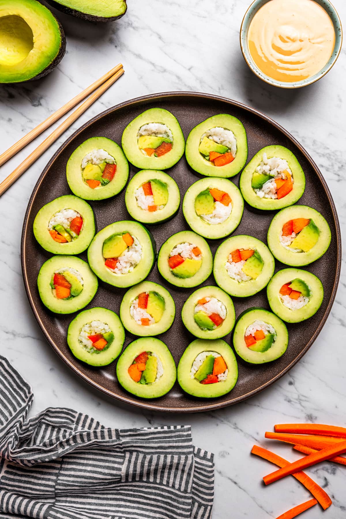 A platter loaded with sliced cucumber rolls.