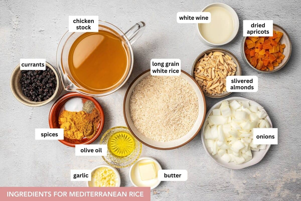 Mediterranean rice is cooked in savory stock and loaded with warm, toasted spices, dried fruits & nuts, & notes of sautéed garlic & onion. Mediterranean rice ingredients with text labels placed over each ingredient.