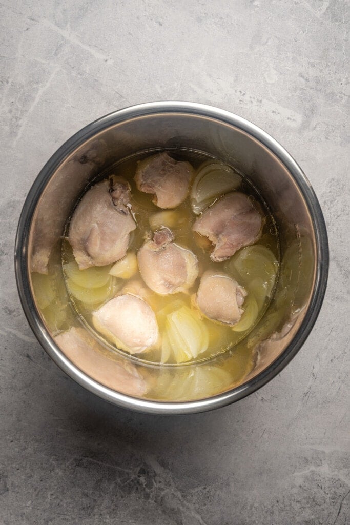 Chicken thighs cooked in the basin of an Instant Pot.