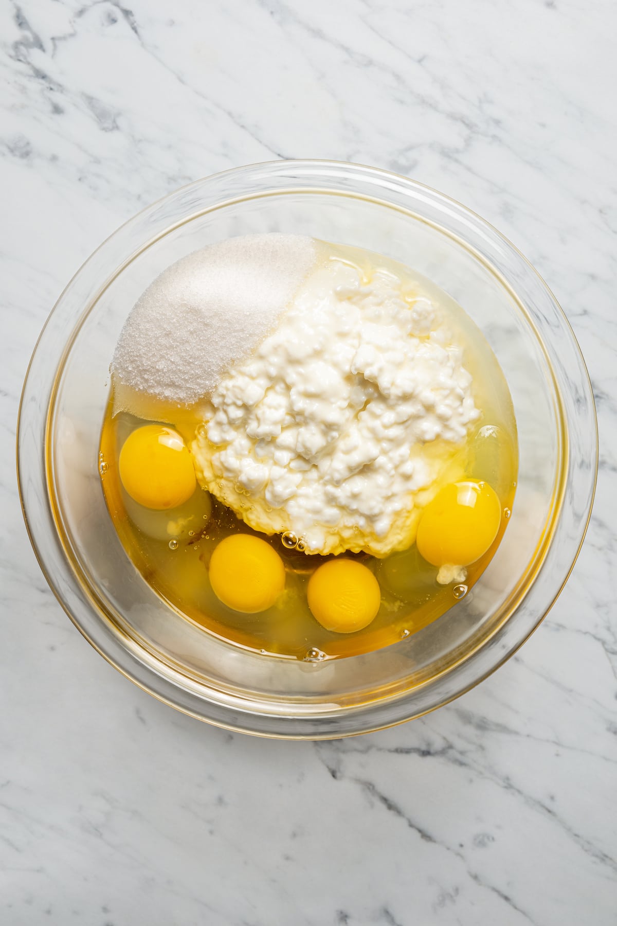 Wet ingredients for cottage cheese pancakes in a bowl.