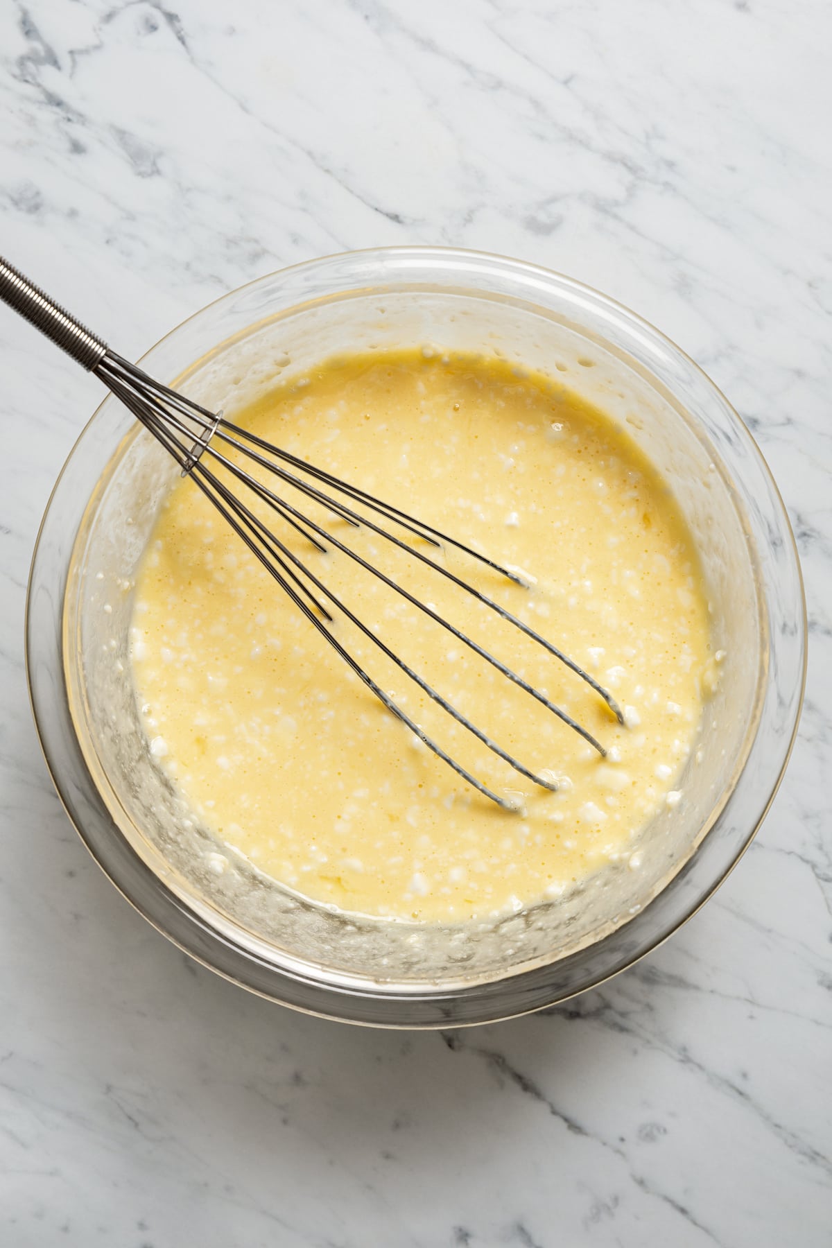 Whisking together wet ingredients for cottage cheese pancakes.