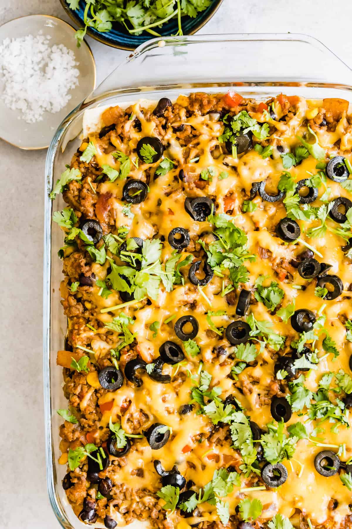 Overhead image of Mexican lasagna in a glass baking dish.