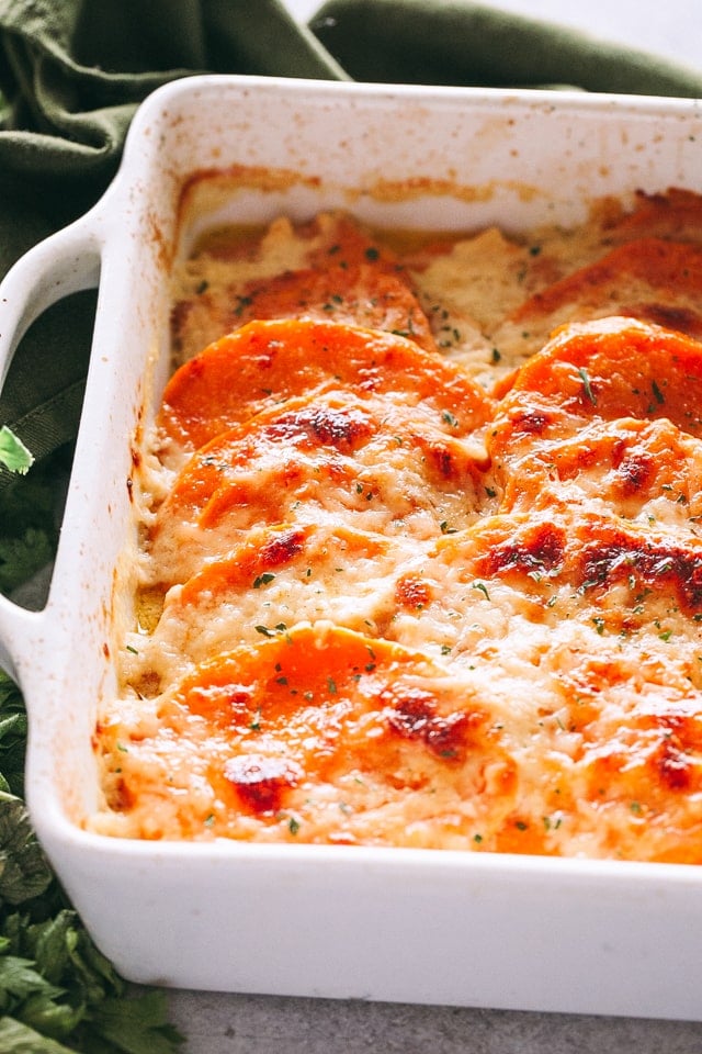 Side shot of sweet potato gratin in a white baking dish.