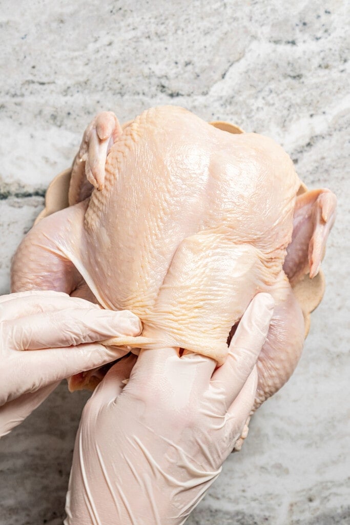 separating the skin from a chicken.