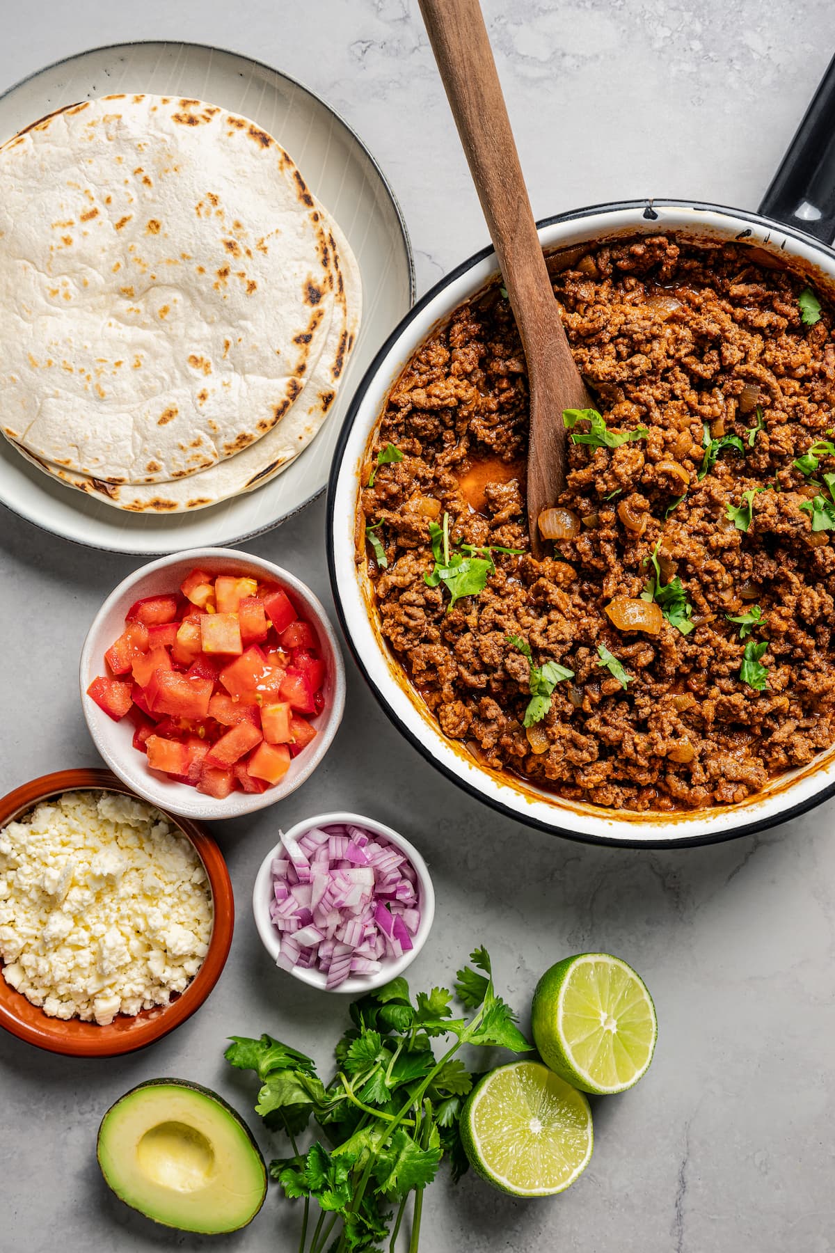 Taco meat along with other popular taco ingredients.