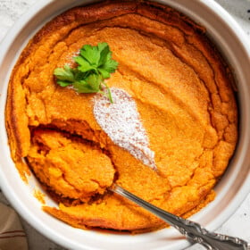Overhead image of carrot souffle with a spoon in it.