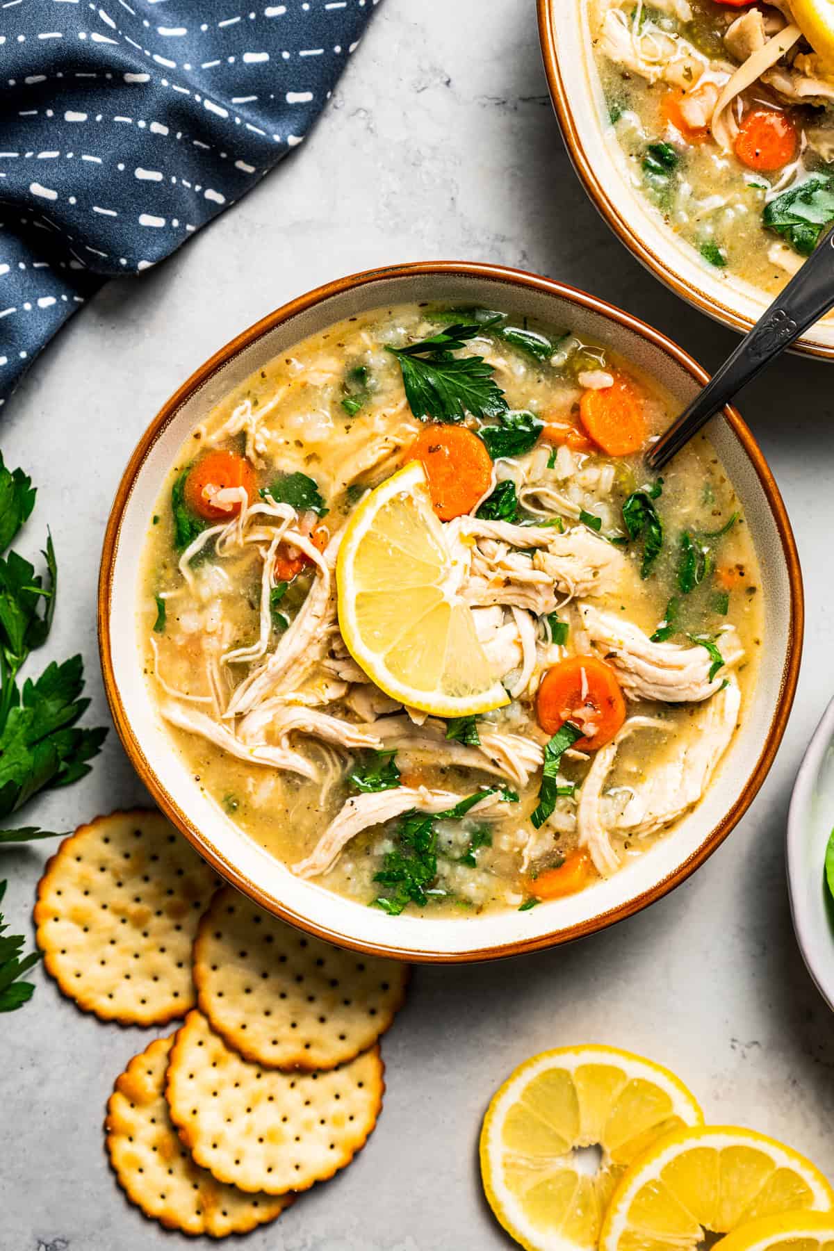 Enjoy a bowl of this Chicken Vegetable Soup packed with shredded chicken, tender veggies, and rice, simmered in a savory broth. Perfect for cozy dinners! Two bowls of chicken soup.