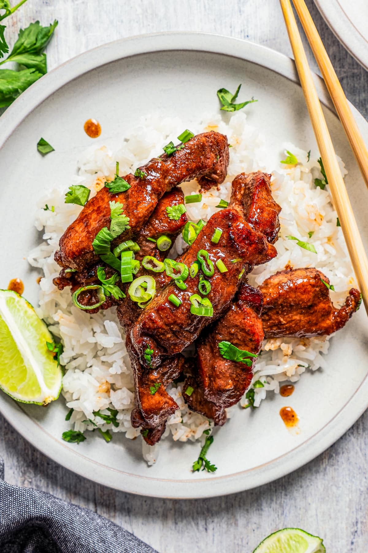 Overhead image of Chinese boneless spare ribs over rice on a plate.
