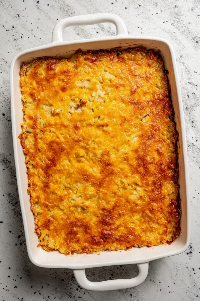Overhead image of baked cheesy hash browns.