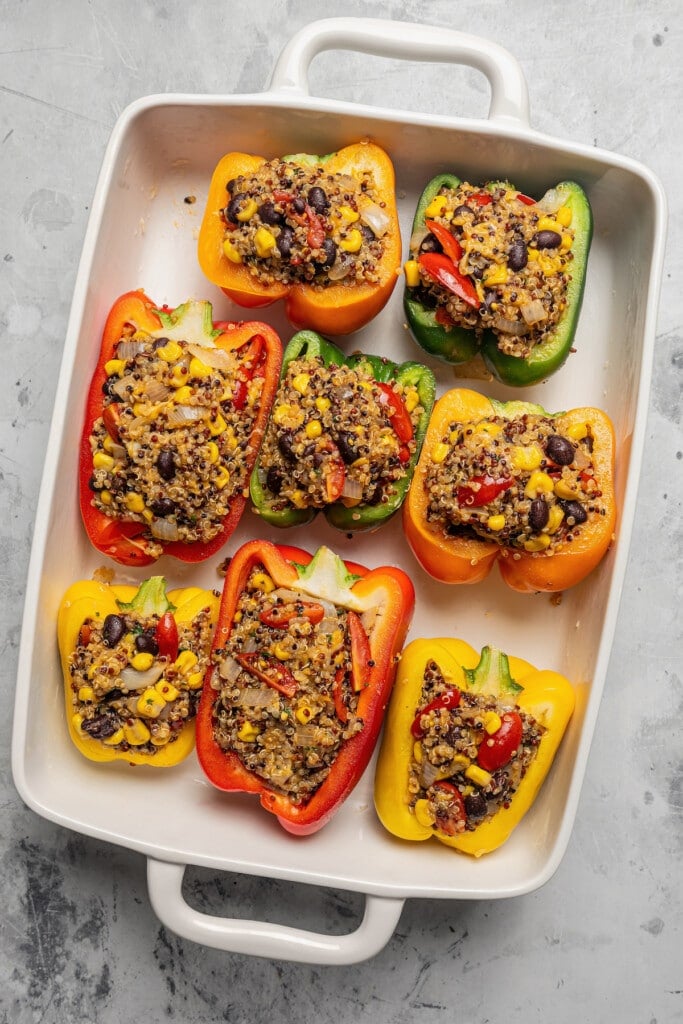 Halved bell peppers stuffed with southwestern quinoa filling.