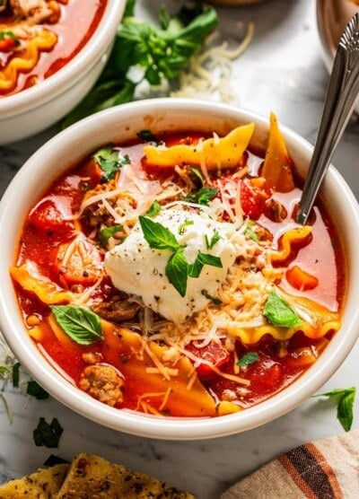 Closeup of lasagna soup in a bowl topped with ricotta.