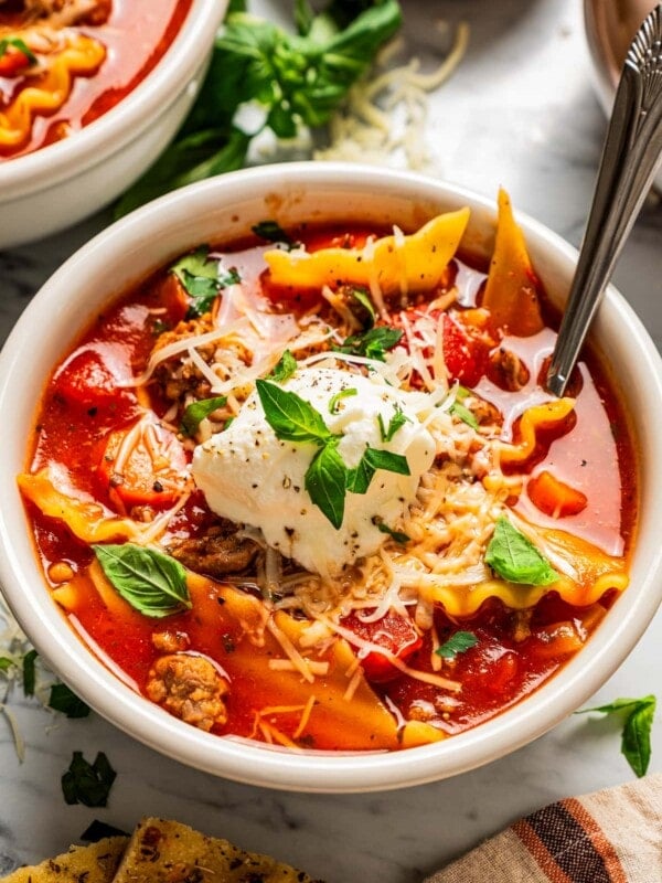 Closeup of lasagna soup in a bowl topped with ricotta.