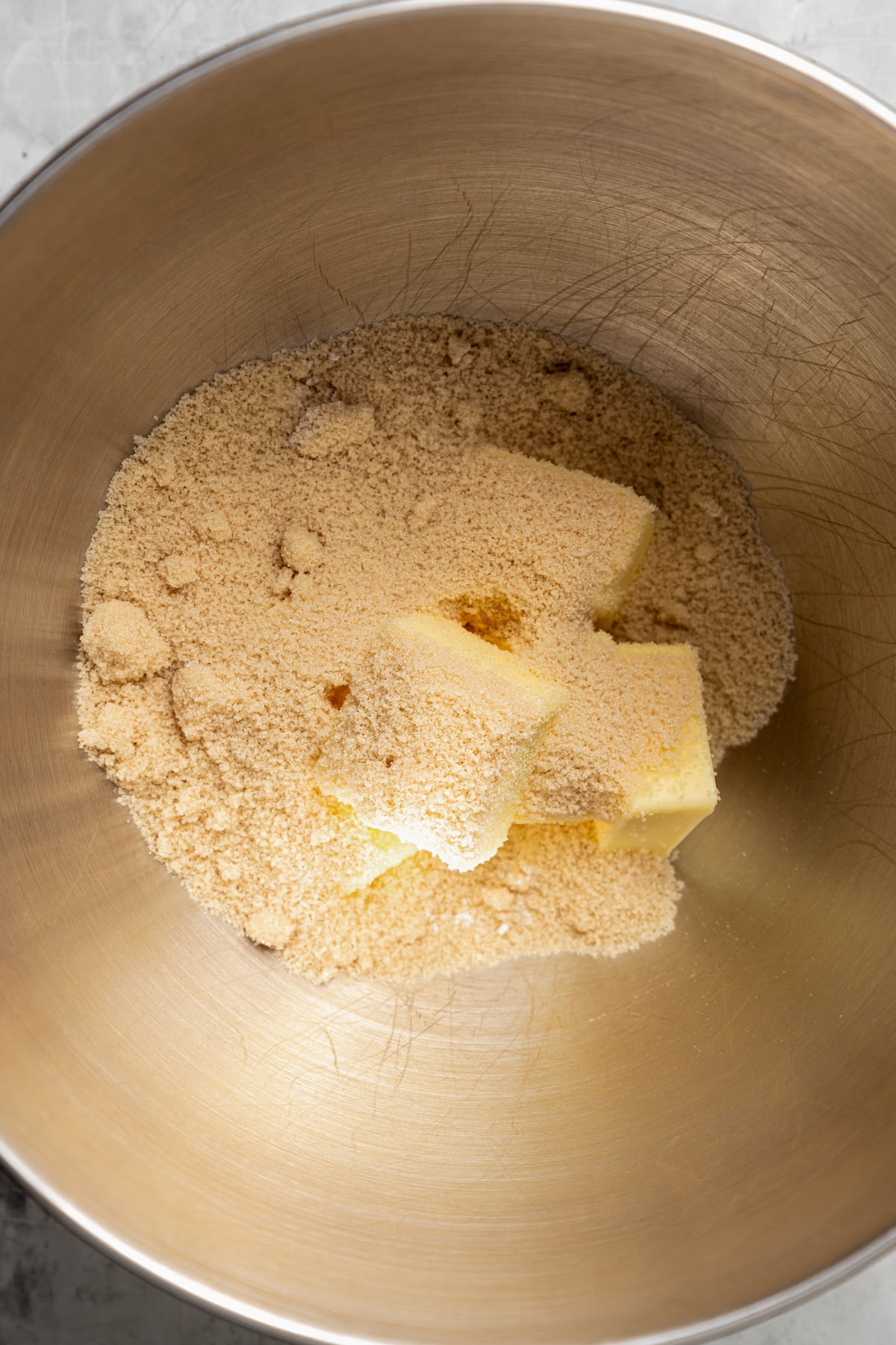 Combining butter and brown sugar in a bowl.