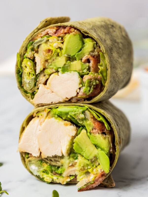 Two stacked caesar wraps with the filling exposed.