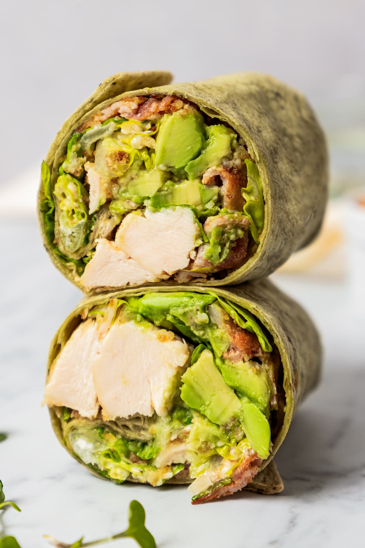 Two stacked caesar wraps with the filling exposed.