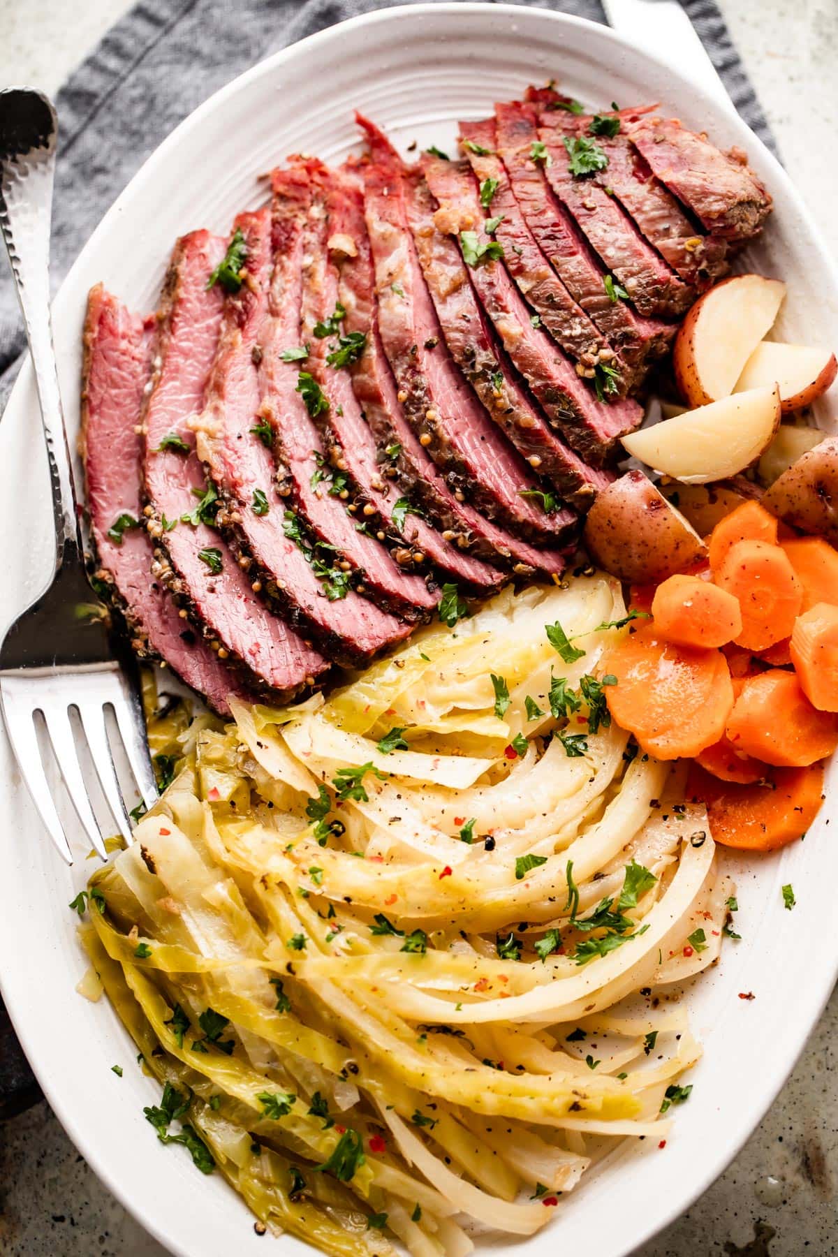 Instant Pot corned beef with cabbage and carrots served on a plate.