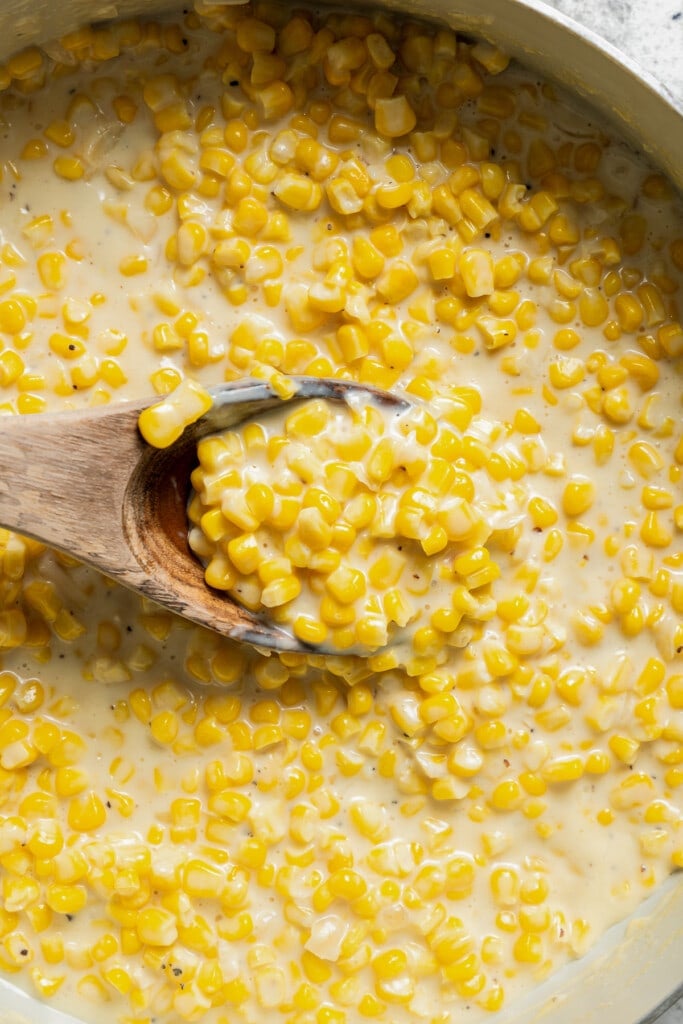 Stirring creamed corn as it thickens.