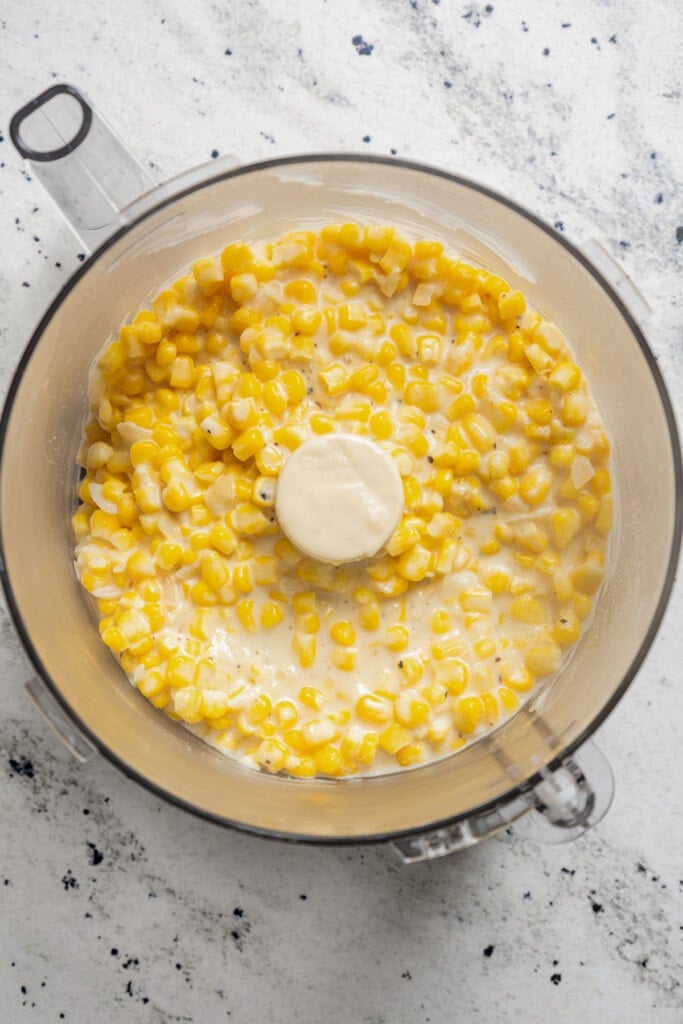 Pureing creamed corn in a food processor.