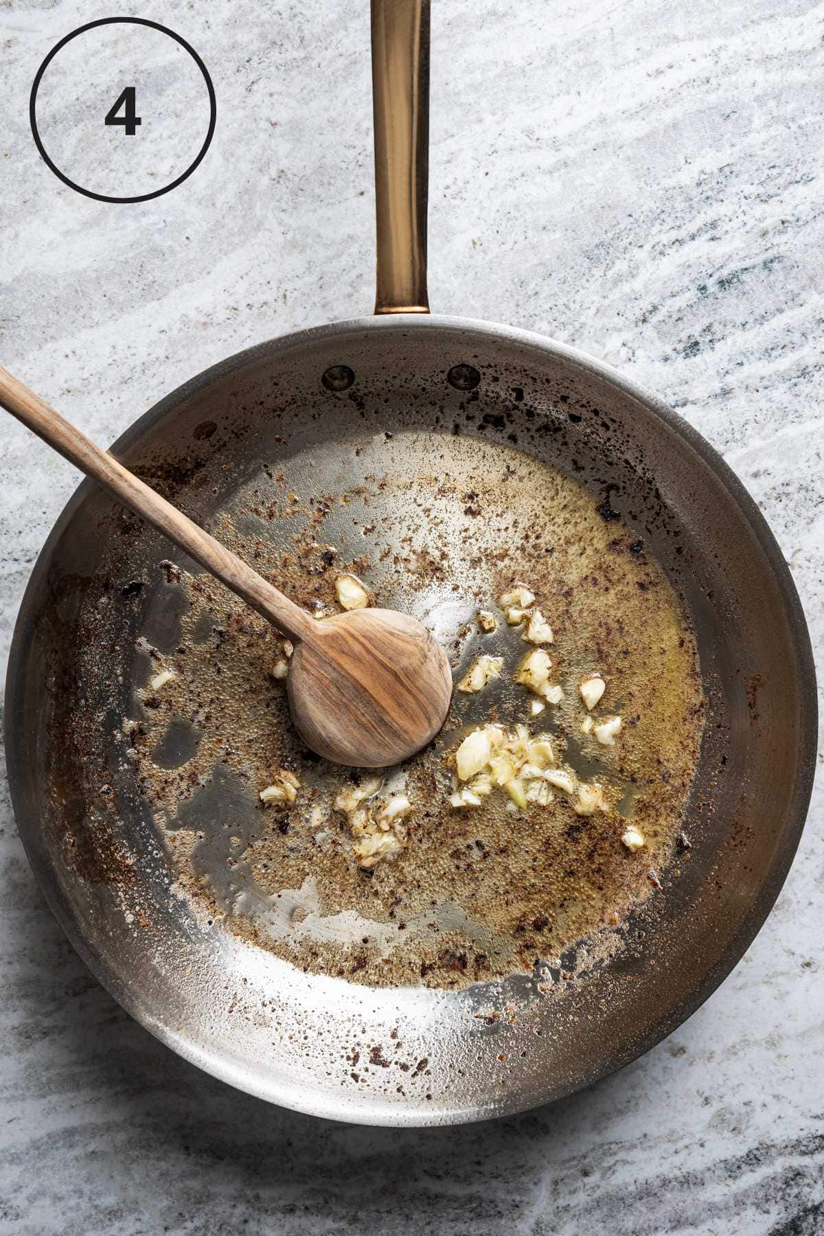 Frying garlic in a skillet.