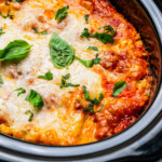 Cooked lasagna in a slow cooker insert.