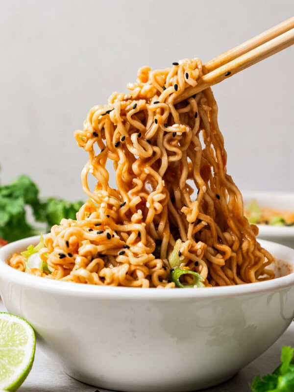 Chopsticks holding up ramen noodles.