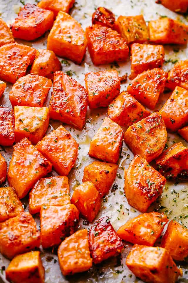 Diced sweet potatoes arranged on a baking sheet.