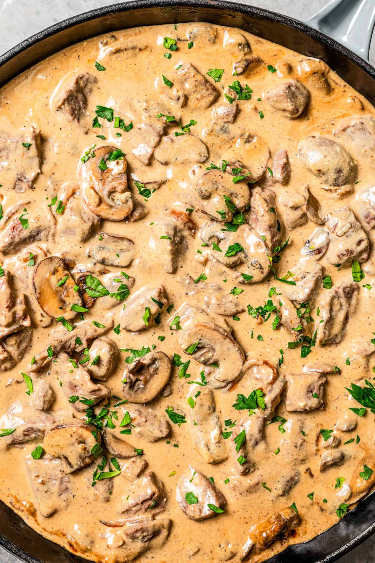 Overhead view of beef stroganoff sauce in a large skillet.