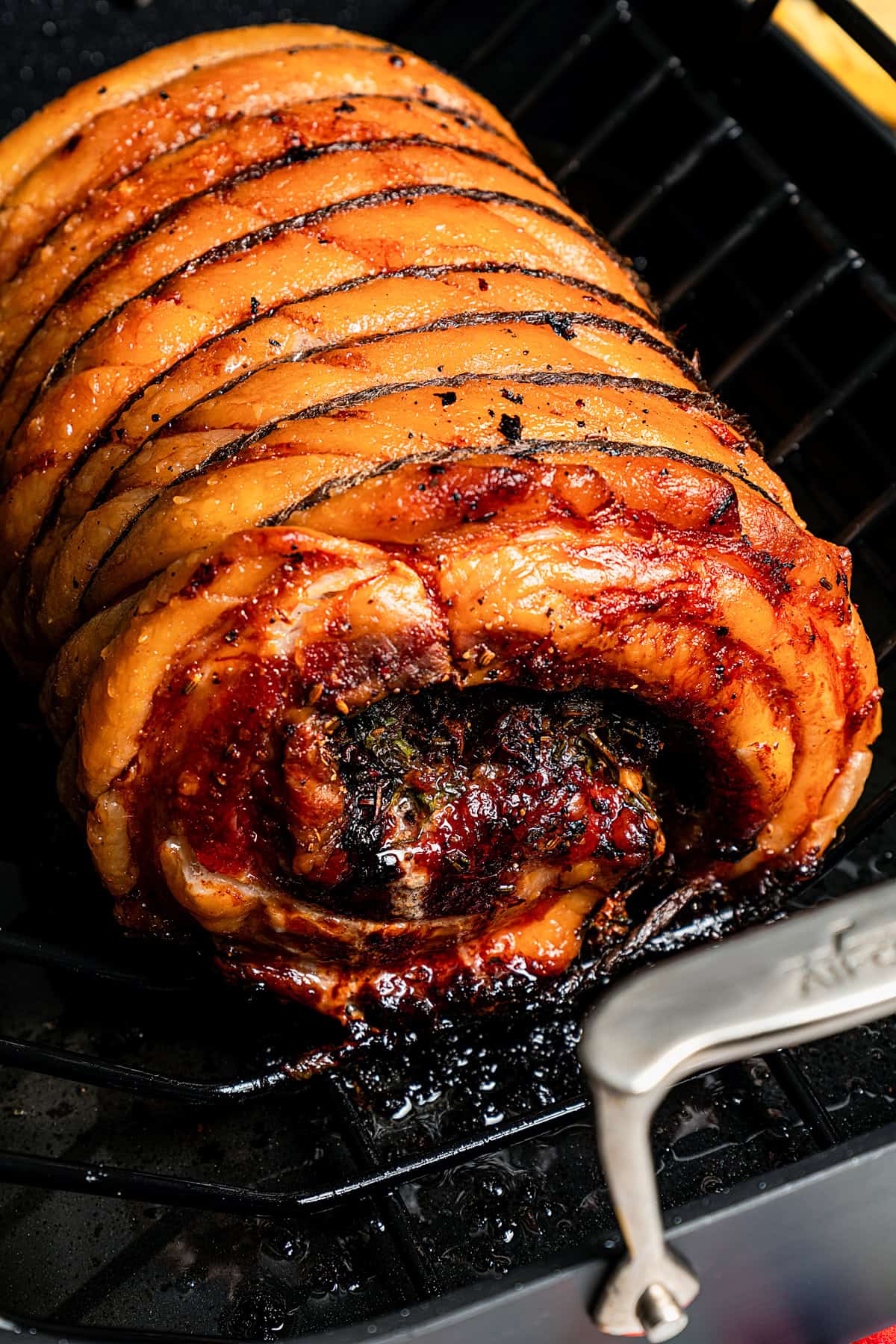 Close up of cooked porchetta in the roasting pan.