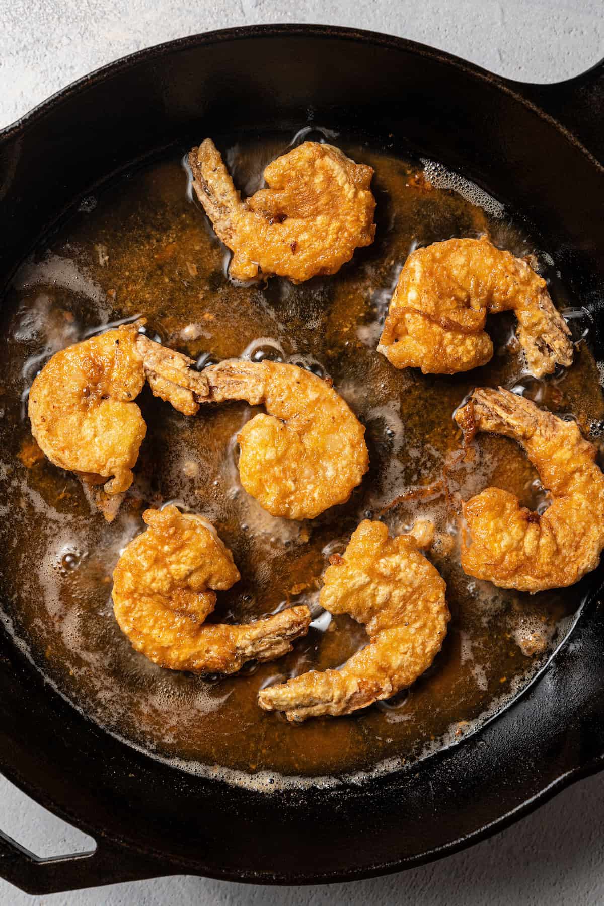 Fried shrimp in a skillet with oil.