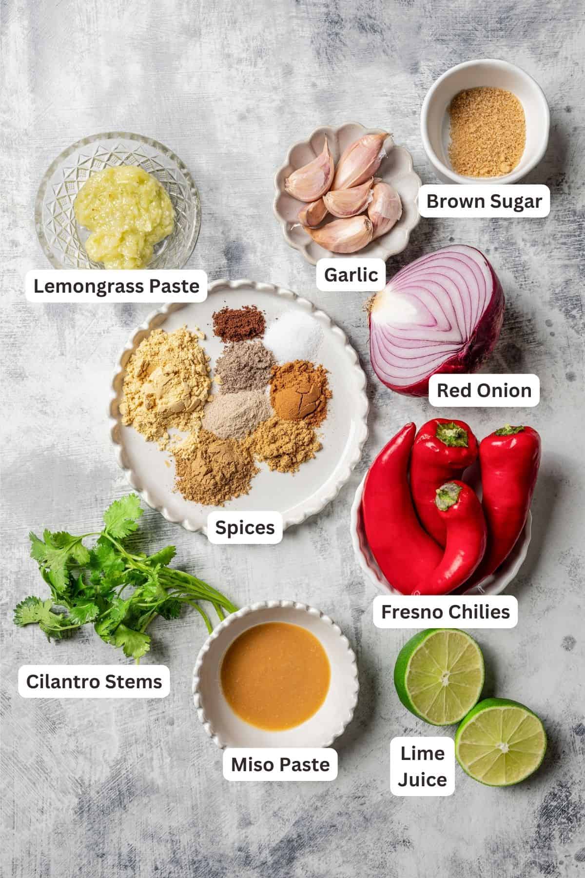 Massaman curry paste ingredients with text labels overlaying each ingredient.